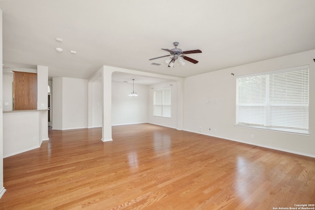 5803 Sugarberry, San Antonio, TX 78253 - unfurnished living room featuring baseboards, visible vents, ceiling fan with notable chandelier, and light wood-style floors