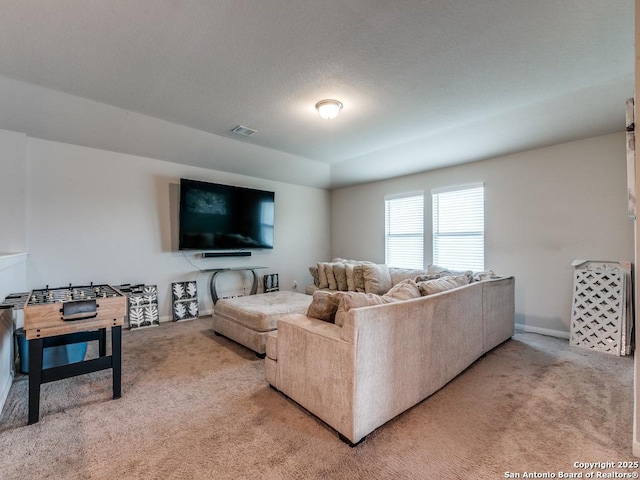living room with baseboards, visible vents, and light colored carpet