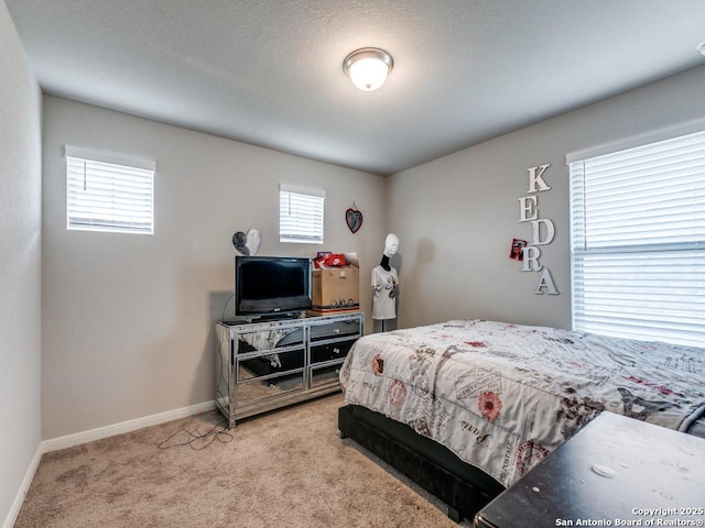 carpeted bedroom with baseboards and multiple windows