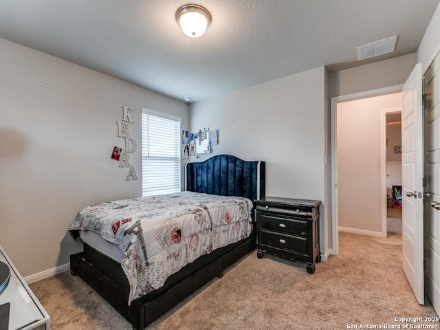 bedroom featuring visible vents, baseboards, and carpet floors