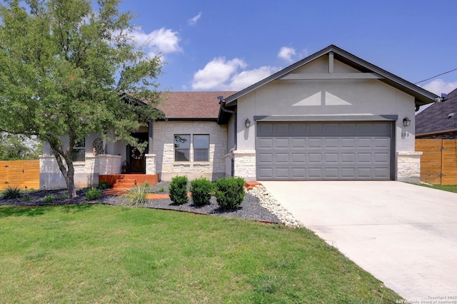 ranch-style home featuring fence, a front yard, stone siding, concrete driveway, and an attached garage