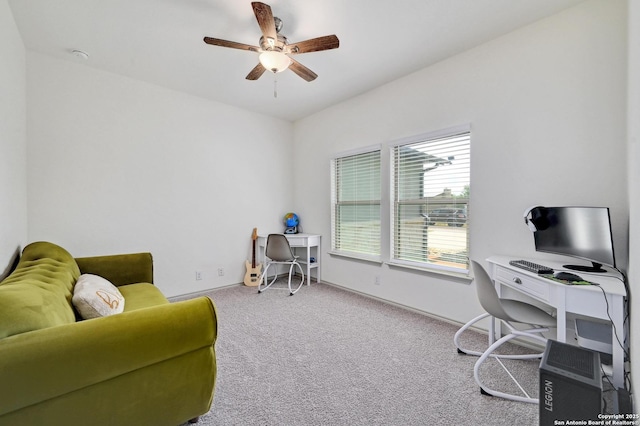 carpeted office featuring ceiling fan and baseboards