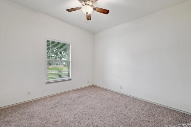 empty room with a ceiling fan, baseboards, and carpet