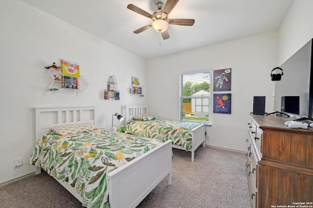 carpeted bedroom with a ceiling fan and baseboards
