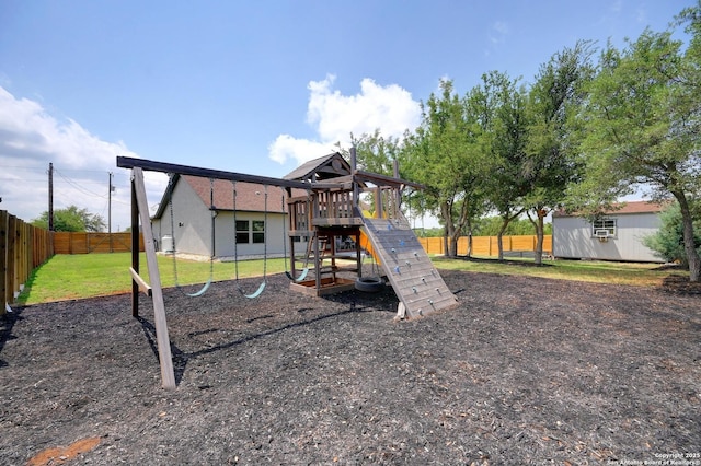 view of playground featuring a fenced backyard and a lawn