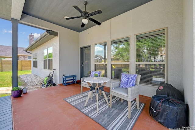 view of patio / terrace with ceiling fan and fence