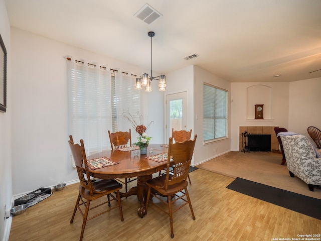 3608 Augusta Glade, Schertz, TX 78154 - dining space with baseboards, visible vents, a tile fireplace, and light wood-type flooring