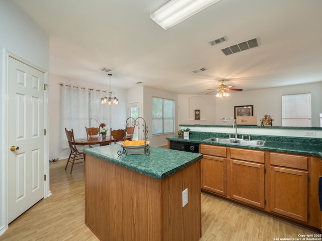 3608 Augusta Glade, Schertz, TX 78154 - kitchen featuring a sink, a center island, brown cabinets, and visible vents