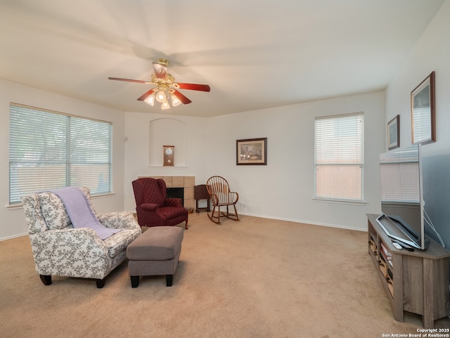 3608 Augusta Glade, Schertz, TX 78154 - sitting room featuring baseboards, ceiling fan, light carpet, and a tile fireplace