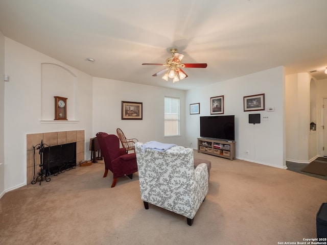 3608 Augusta Glade, Schertz, TX 78154 - living area with a tiled fireplace, baseboards, a ceiling fan, and light colored carpet