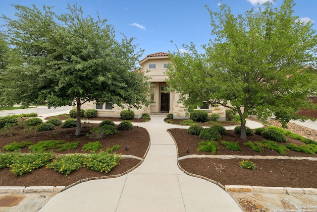view of front of house with a tile roof and stucco siding