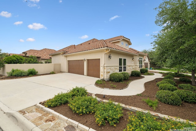 view of home's exterior featuring a tile roof, stone siding, a garage, stucco siding, and concrete driveway