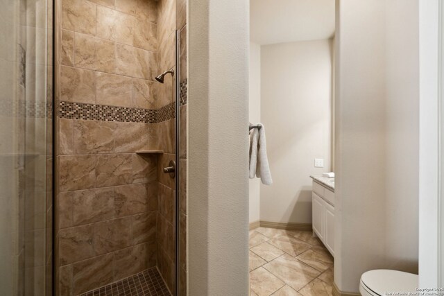 full bath with vanity, a shower stall, and tile patterned floors