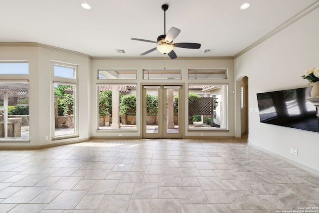 unfurnished living room with crown molding, baseboards, a ceiling fan, and visible vents