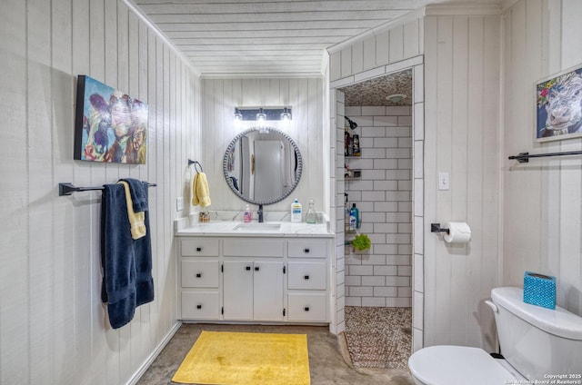 433 Mills Ln, Uvalde, TX 78801 - bathroom featuring toilet, concrete flooring, tiled shower, and vanity