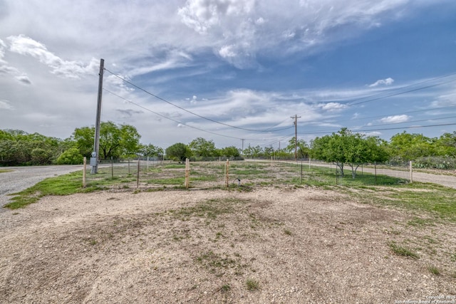 exterior space featuring fence and a rural view