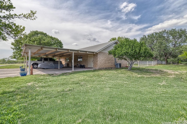 exterior space featuring fence and a carport