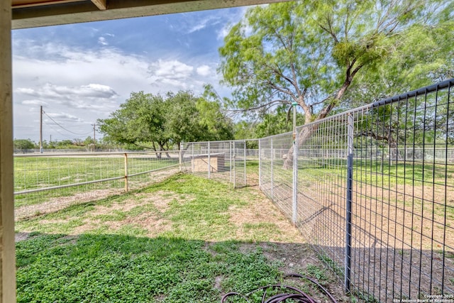 view of yard with a rural view and fence
