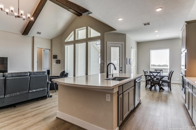 kitchen featuring visible vents, baseboards, light wood-type flooring, a sink, and appliances with stainless steel finishes
