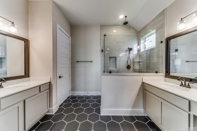 full bathroom featuring a sink, walk in shower, and two vanities