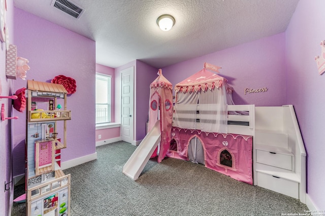 carpeted bedroom with baseboards, a textured ceiling, and visible vents