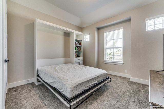 carpeted bedroom featuring baseboards