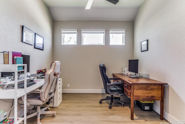 office featuring baseboards, light wood-style flooring, and ceiling fan