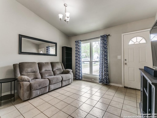 living room with an inviting chandelier, baseboards, light tile patterned floors, and vaulted ceiling