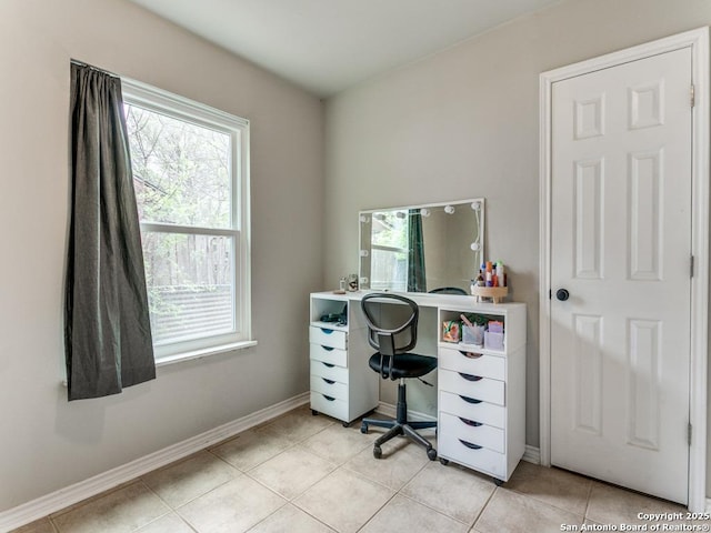 office space with light tile patterned floors and baseboards
