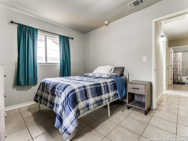 bedroom featuring visible vents, baseboards, and light tile patterned flooring