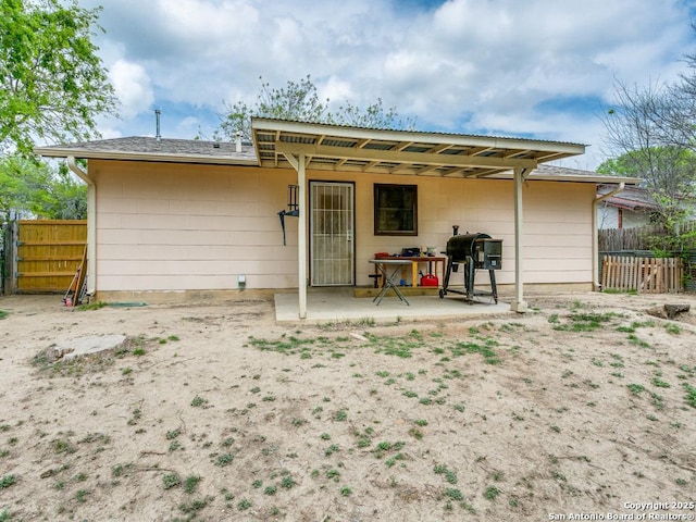 back of house featuring a patio area and fence