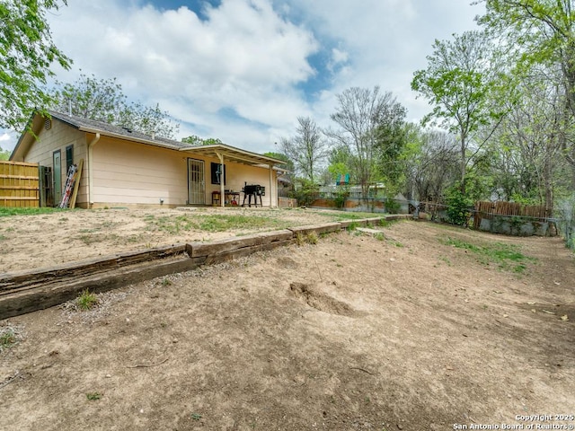 back of house with fence