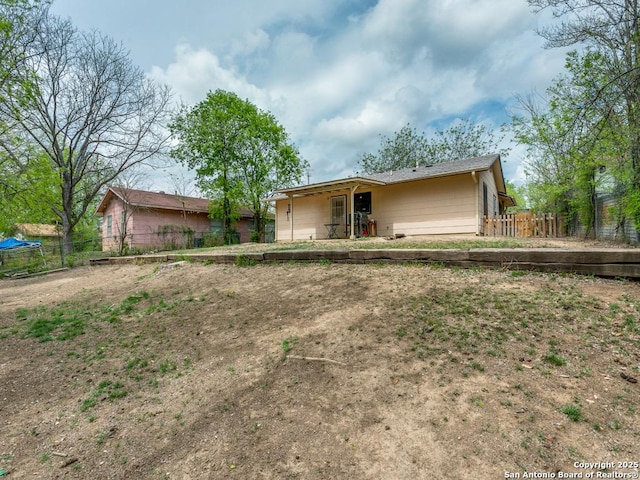 back of property with fence