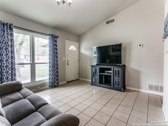 living area with light tile patterned flooring, visible vents, and a wealth of natural light