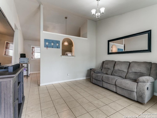 living room with light tile patterned floors, baseboards, and vaulted ceiling