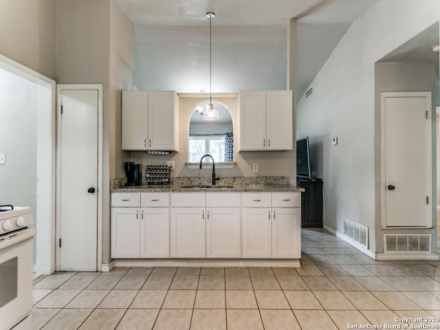 kitchen with visible vents, a sink, white electric range oven, and stone counters
