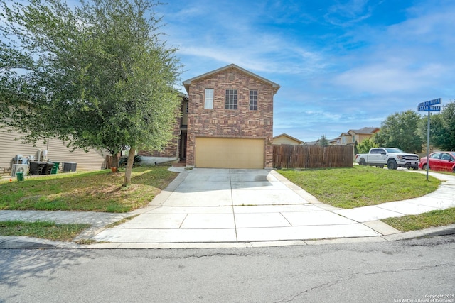 traditional-style home with fence, a front lawn, concrete driveway, an attached garage, and stone siding