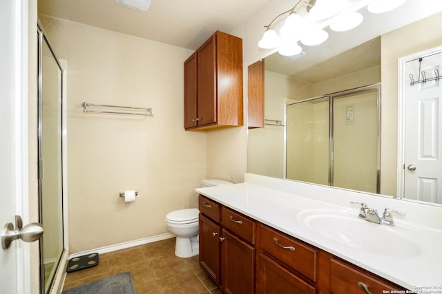 full bath featuring tile patterned flooring, a stall shower, vanity, baseboards, and toilet