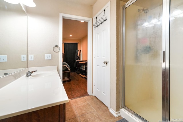 full bathroom with recessed lighting, tile patterned floors, a shower stall, and vanity