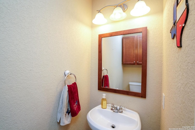 half bathroom with a sink and toilet