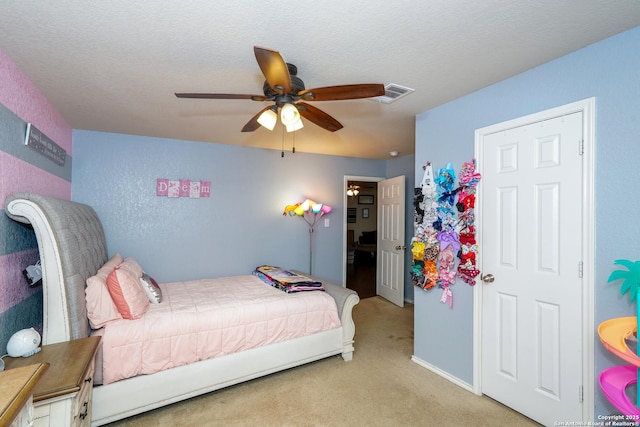 bedroom featuring carpet flooring, a ceiling fan, and visible vents