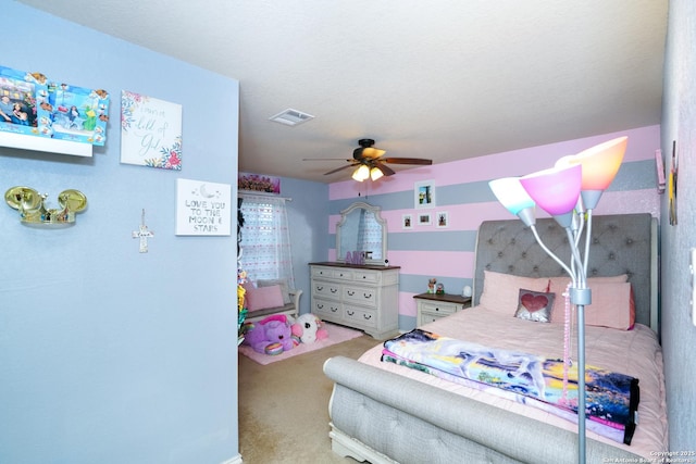 carpeted bedroom featuring ceiling fan and visible vents