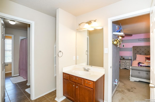 full bath featuring vanity, baseboards, and tile patterned flooring