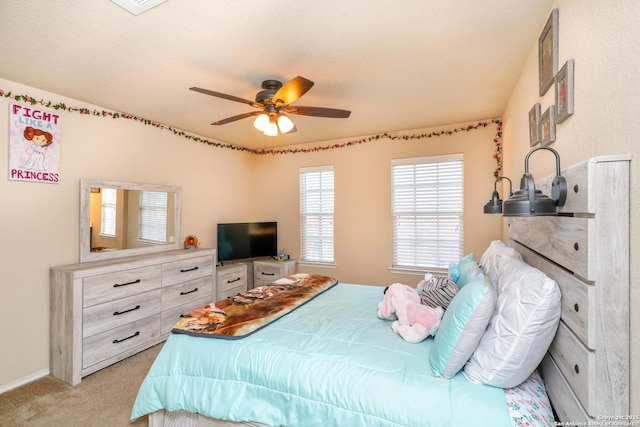 bedroom with a ceiling fan and light carpet