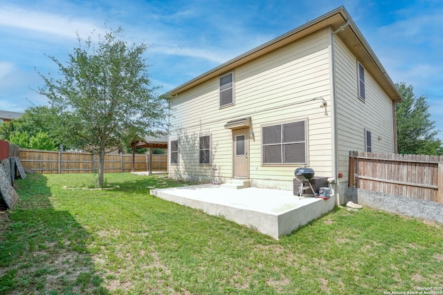 rear view of property featuring a fenced backyard, a patio area, a yard, and entry steps