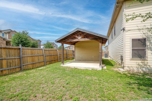 view of yard featuring central AC, a patio area, and fence