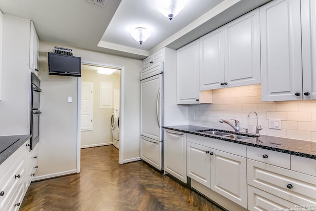 200 Patterson Unit 312, San Antonio, TX 78209 - kitchen featuring decorative backsplash, dark stone counters, white cabinetry, a sink, and independent washer and dryer
