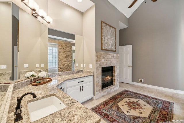 11822 Elmscourt, San Antonio, TX 78230 - full bathroom featuring a sink, high vaulted ceiling, ceiling fan, and a fireplace
