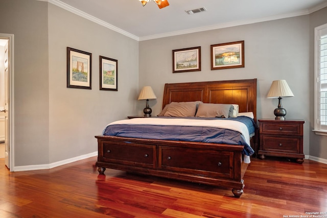 bedroom with visible vents, ornamental molding, wood finished floors, baseboards, and multiple windows
