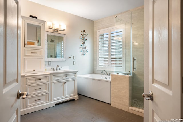 bathroom featuring vanity, a shower stall, tile patterned floors, and a garden tub